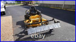 Swinging Tool Bar and Rake Ezra Lawn Care Equipment mounts on a zero turn mower