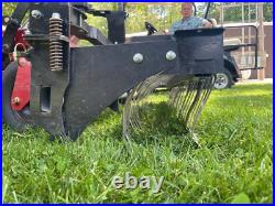 Swinging Tool Bar and Rake Ezra Lawn Care Equipment mounts on a zero turn mower